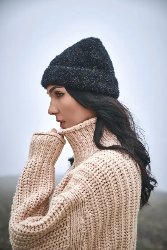 Model wearing a black chunky beanie