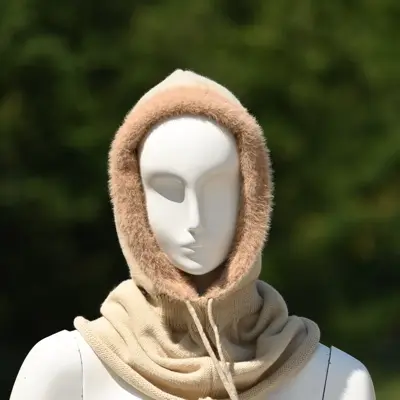 Beige knitted hood with a fluffy trim