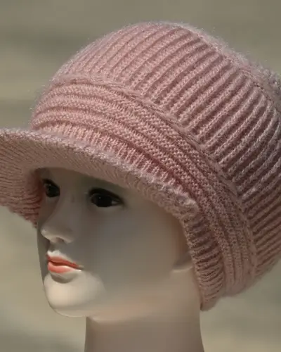 Pink knitted cap with a visor